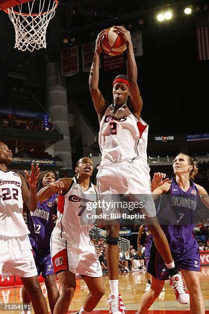 Michelle Snow of the Houston Comets grabs a rebound against Erin Buescher of the Sacramento Monarchs during the WNBA game July 2, 2006 at the Toyota...