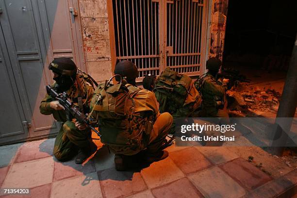 Elite Israeli army soldiers storm the Hamas charitable movement offices during an overnight operation in the early morning hours of July 3, 2006 in...