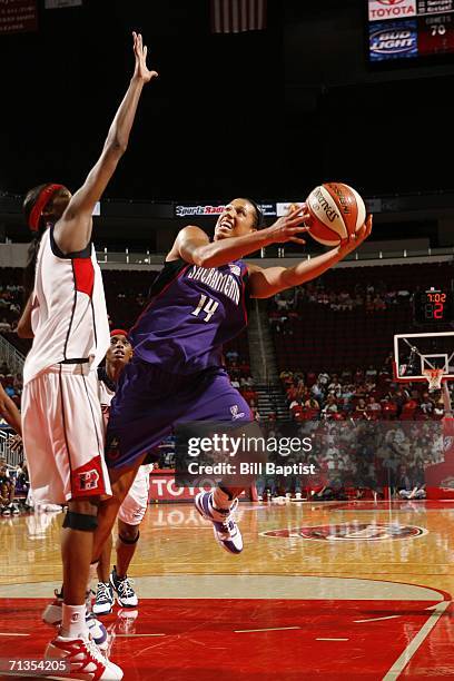 Nicole Powell of the Sacramento Monarchs shoots against Michelle Snow of the Houston Comets during the WNBA game July 2, 2006 at the Toyota Center in...