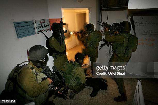 Elite Israeli army soldiers storm the Hamas charitable movement offices during an overnight operation in the early morning hours of July 3, 2006 in...