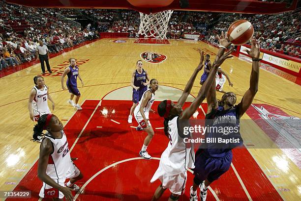 Yolanda Griffith of the Sacramento Monarchs grabs a rebound over Michelle Snow of the Houston Comets during the WNBA game July 2, 2006 at the Toyota...