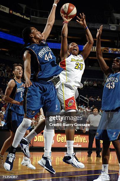 Cappie Pondexter of the Phoenix Mercury shoots against Chasity Melvin of the Washington Mystics July 2 at U.S. Airways Center in Phoenix, Arizona....