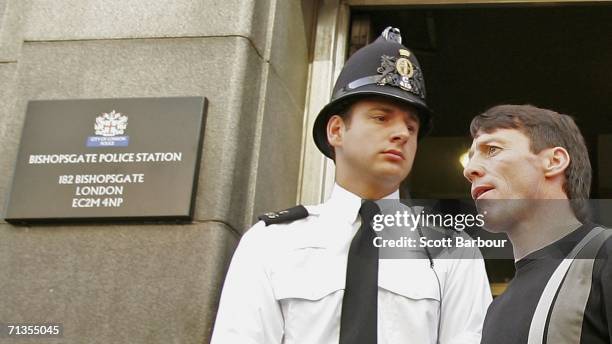 Jockey Kieren Fallon is watched by a police officer as he leaves Bishopsgate police station on July 3, 2006 in London, England. Fallon was one of 28...