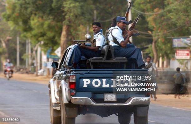 Policemen with the Tamil Tiger guerrillas patrol on a highway, in the outskirts of the rebel-held town of Kilinochchi, some 250 kilometers north of...