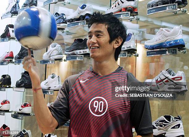 Indian footballer and Nike brand ambassador Baichun Bhutia spins a football at the launch of the "Total 90" range of football products in Mumbai, 03...