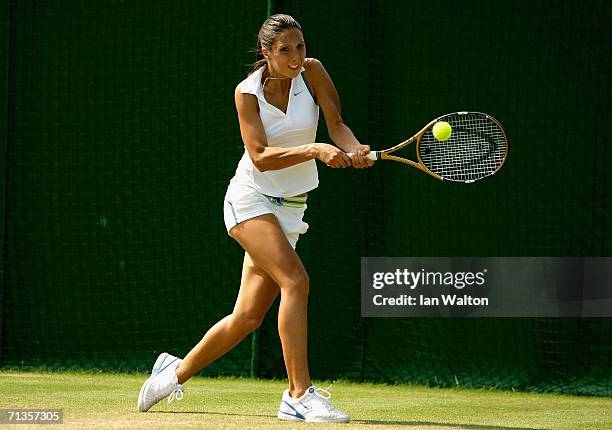 Anastasia Myskina of Russia returns a backhand to Jelena Jankovic of Serbia and Montenegro during day seven of the Wimbledon Lawn Tennis...