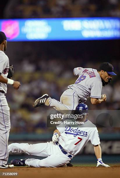 Jose Valentin of the New York Mets makes a double play as J.D. Drew of the Los Angeles Dodgers slides to second base at Dodger Stadium on June 5,...