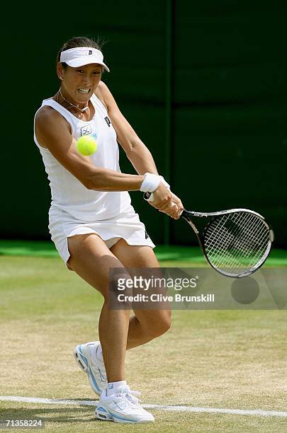 Ai Sugiyama of Japan returns a backhand to Severine Bremond of France during day seven of the Wimbledon Lawn Tennis Championships at the All England...