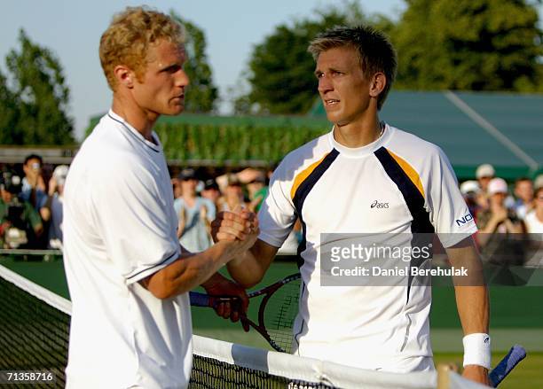 Jarkko Nieminen of Finland is congratulated by Dmitry Tursunov of Russia during day seven of the Wimbledon Lawn Tennis Championships at the All...
