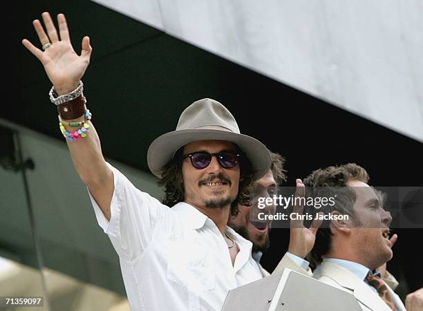 Actor Johnny Depp waves from the balcony of the Odeon cinema at the European Premiere of 'Pirates Of The Caribbean: Dead Man's Chest' at the Odeon...