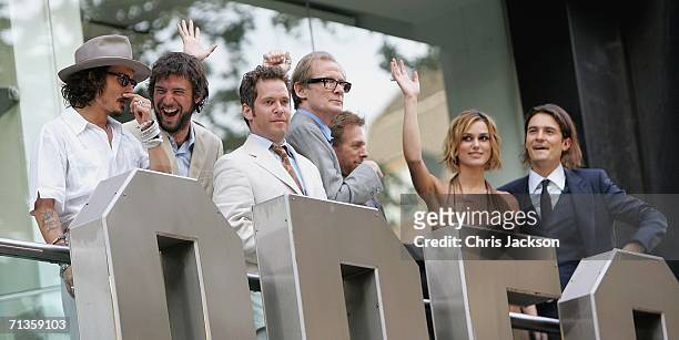 Actors Johnny Depp, guest, Tom Hollander, Bill Nighy, Keira Knightley and Orlando Bloom wave from the balcony of the Odeon at the European Premiere...