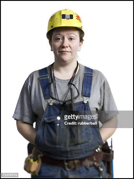 portrait of a female coal miner standing with her hands in her pockets - miner helmet portrait stock pictures, royalty-free photos & images