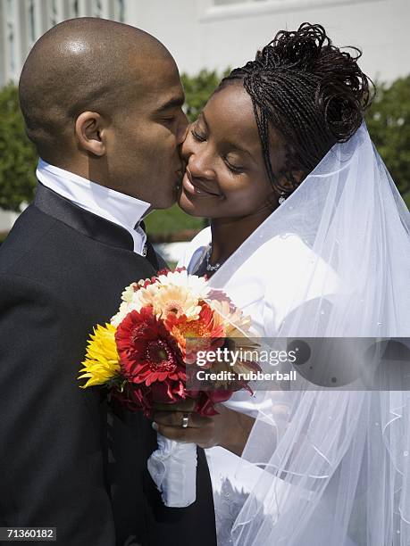 profile of a groom kissing his bride - braided buns stock pictures, royalty-free photos & images