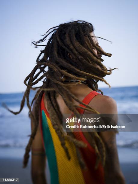 rear view of a young man on the beach - dreadlocks back stock pictures, royalty-free photos & images