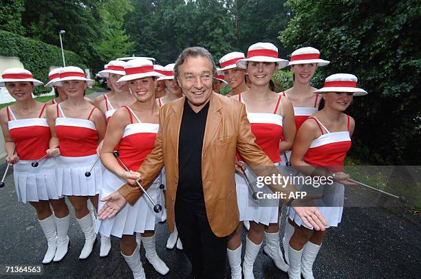 Jevany, CZECH REPUBLIC: Karel Gott, enduring Czech and international pop idol, poses next to a group of majorettes as he inaugurates 30 June 2006 his...