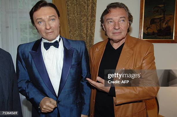 Jevany, CZECH REPUBLIC: Karel Gott, enduring Czech and international pop idol, poses next to his wax figure as he inaugurates 30 June 2006 his own...
