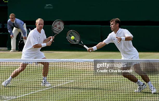 Pavel Vizner and Lukas Dlouhy of Czech Republic in action during their doubles match against Mike Bryan and Bob Bryan of the United States during day...