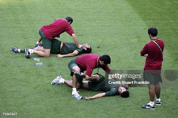 Cristiano Ronaldo and Figo of Portugal receives some treatment from a physiotherapist during the training session of Portugal National Team at the...