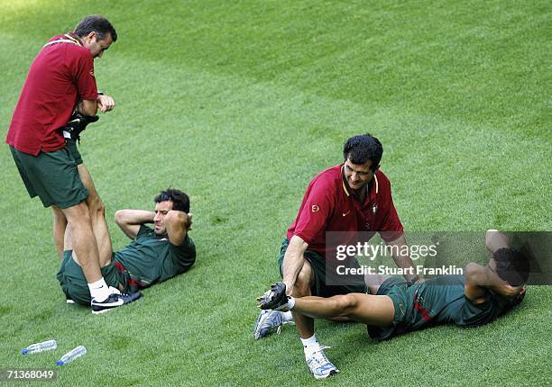 Cristiano Ronaldo and Figo of Portugal receivessome treatment from a physiotherapist during the training session of Portugal National Team at the...