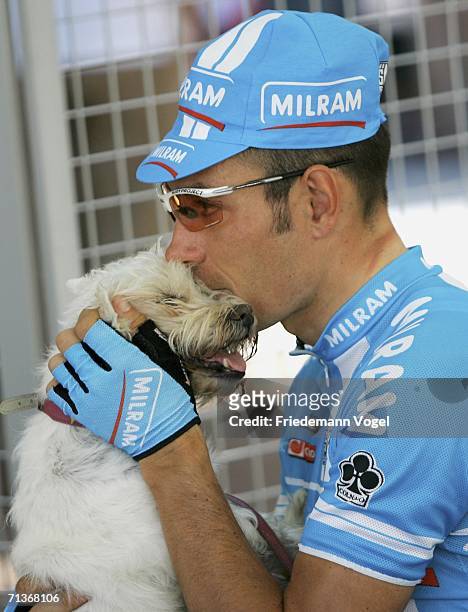 Erik Zabel of Germany and the Milram Team relaxes with his dog before Stage 3 of the 93rd Tour de France between Esch-sur-Alzette and Valkenburg on...