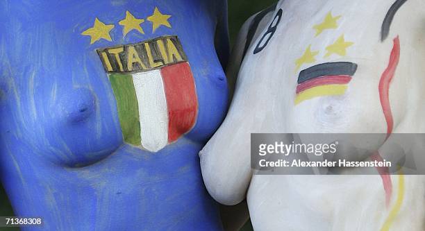 Two young women pose in body paint before watching the FIFA World Cup 2006 Semi Finale match between Germany and Italy at the Fan Fest outdoor...