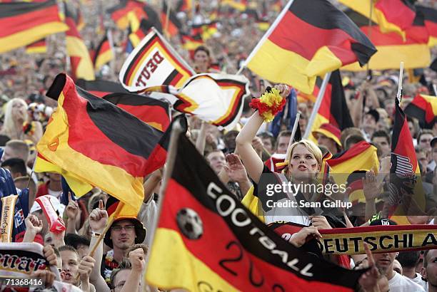 Germany soccer fans wave German national flags prior to watching the FIFA World Cup 2006 Semi Finals match between Germany and Italy at the Fan Fest...