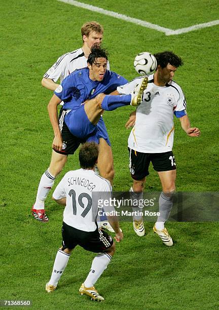 Luca Toni of Italy gets his foot to the ball under pressure from Per Mertesacker, Bernd Schneider and Michael Ballack of Germany during the FIFA...