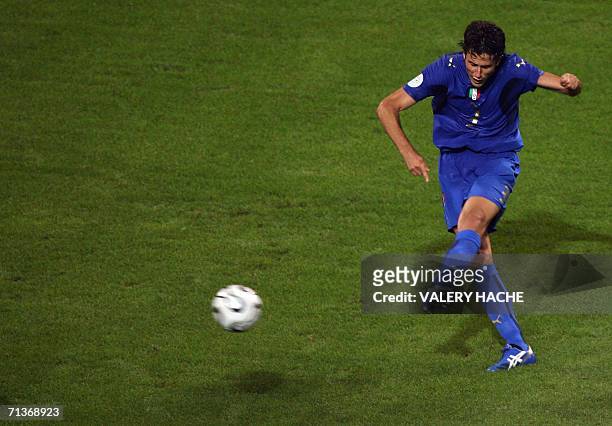 Italian defender Fabio Grosso kicks the ball to score the opening goal during the extra-time of the World Cup 2006 semi final football match Germany...