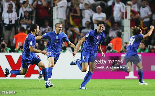 Fabio Grosso of Italy celebrates scoring his team's first goal in extra time with team mates Gianluca Zambrotta and Alessandro Del Piero during the...