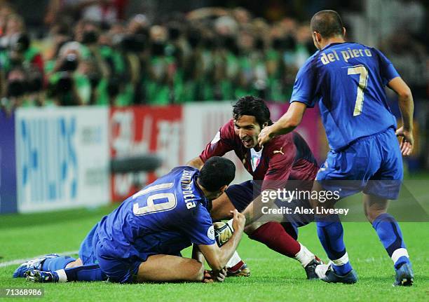 Fabio Grosso of Italy celebrates scoring his team's first goal in extra time with team mates Gianluca Zambrotta, Gianluigi Buffon and Alessandro Del...