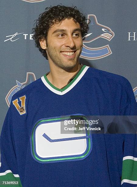 Goaltender Roberto Luongo wears a Vancouver Canuck jersey as he faces the media for the first time since his trade to the Vancouver Canucks from the...