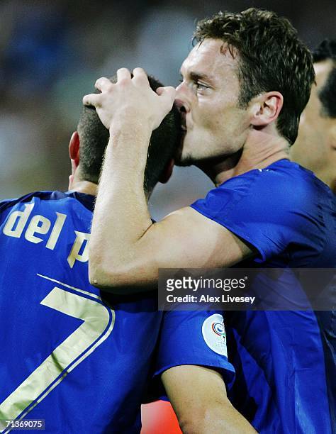 Alessandro Del Piero of Italy is kissed by team mate Francesco Totti after scoring his team's second goal in extra time during the FIFA World Cup...