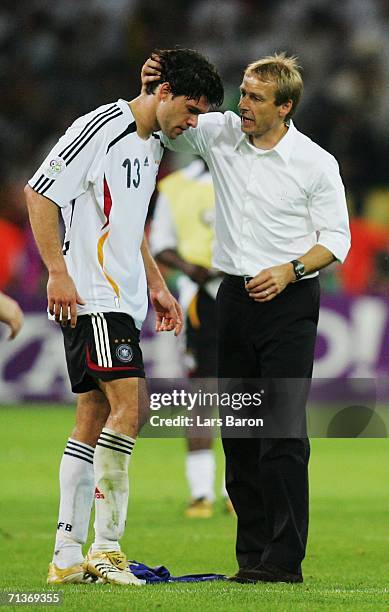 Michael Ballack of Germany is consoled by Manager Juergen Klinsmann following their team's defeat at the end of the FIFA World Cup Germany 2006...