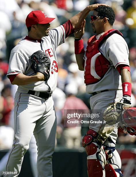 Pitcher J.C. Romero congratulates catcher Jose Molina after defeating the Seattle Mariners 14-6 on July 4, 2006 at Safeco Field in Seattle,...