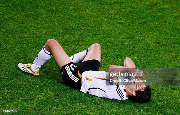 Michael Ballack of Germany clutches his face during the FIFA World Cup Germany 2006 Semi-final match between Germany and Italy played at the Stadium...
