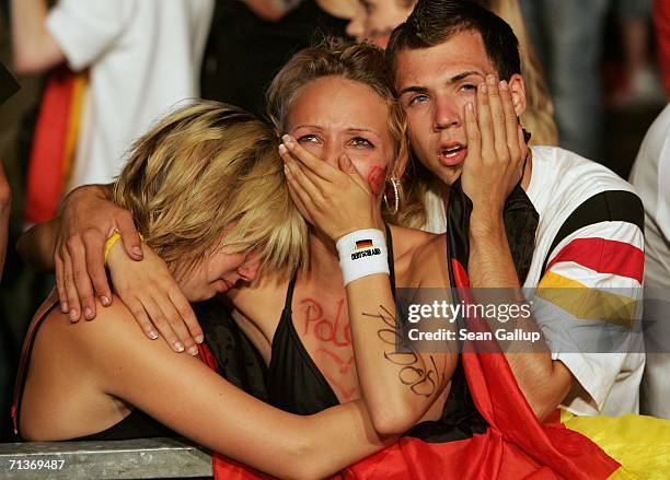 Weeping Germany soccer fans console one another after watching the FIFA World Cup 2006 Semi Finals match between Germany and Italy at the Fan Fest...