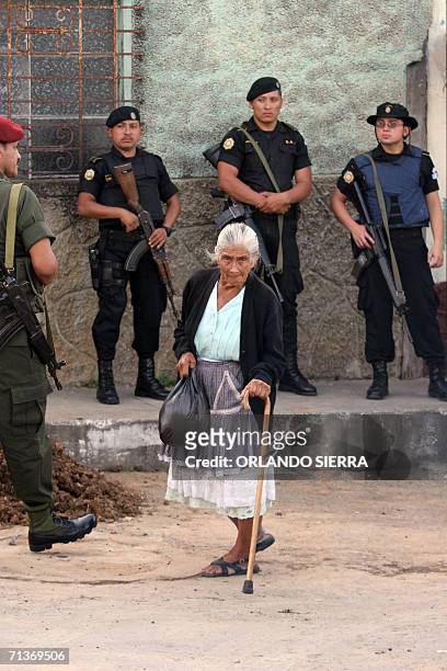 Una anciana camina por una calle centricad el barrio El Gallito de Ciudad de Guatemala, donde soldados y agentes de la Policia Nacional Civil montan...