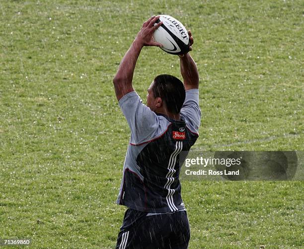 Hooker Keven Mealamu throws the ball into the lineout in rainy conditions during an All Blacks training session at Rugby Park on July 05, 2006 in...
