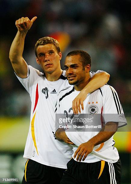 David Odonkor of Germany is consoled by team mate Lukas Podolski following their team's defeat at the end of the FIFA World Cup Germany 2006...