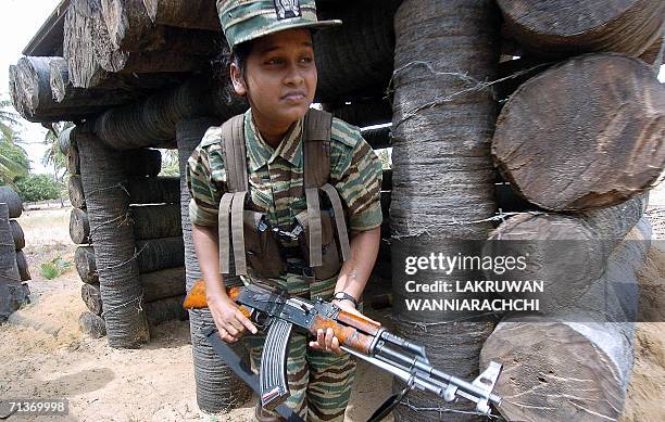 Female Liberation Tigers of Tamil Eelam guerrillas crawls out of a bunker located near the rebel front, 03 July 2006 north of the Tiger-controlled...
