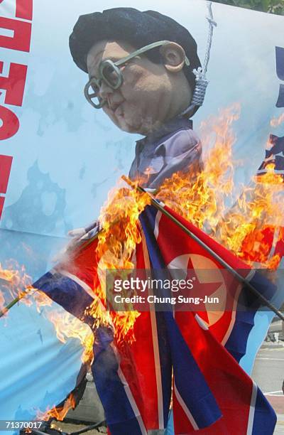South Korean protesters burn North Korean flags and a poster featuring a cariciture of North Korean leader Kim Jong-Il during an anti-North Korea...