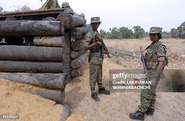 Female Liberation Tigers of Tamil Eelam guerrillas stand outside a bunker located near the rebel front, 03 July 2006 north of the Tiger-controlled...