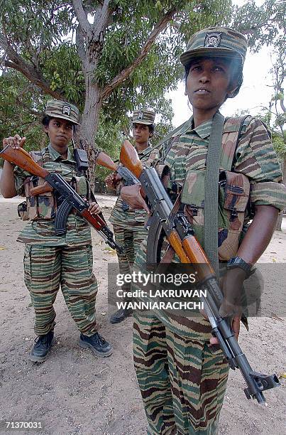 Female Liberation Tigers of Tamil Eelam guerrillas stand outside a bunker located near the rebel front, 03 July 2006 north of the Tiger-controlled...