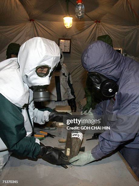 Japanese Abandoned Chemical Weapons expert together with his Chinese counterpart measure and identify one of the chemical bombs excavated from a...