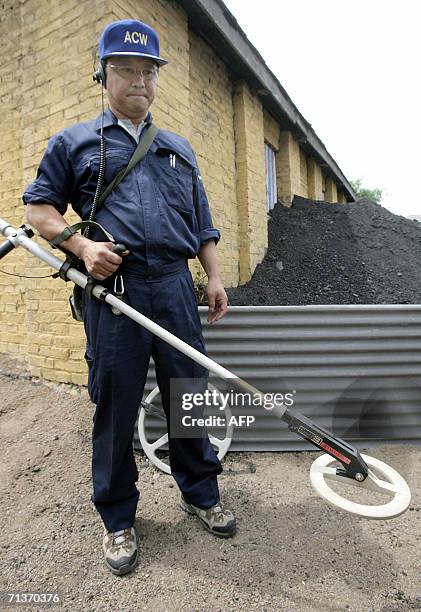 Japanese Abandoned Chemical Weapons expert shows off one of the equipments used to locate the buried chemical bombs at a site, which is opposite a...