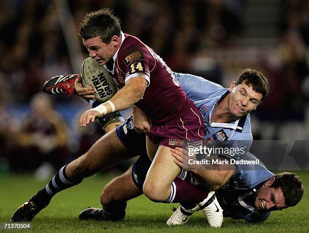 Shaun Berrigan of Queensland is tackled by Steve Simpson of New South Wales during game three of the ARL State of Origin series between the New South...