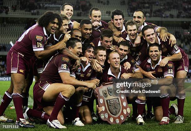 The victorious Queensland Maroons celebrate with the Harvey Norman State of Origin trophy after winning game three of the ARL State of Origin series...