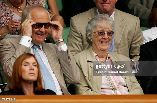 Musician Sir Tim Rice and guest watch from the Royal Box on Centre Court during day nine of the Wimbledon Lawn Tennis Championships at the All...