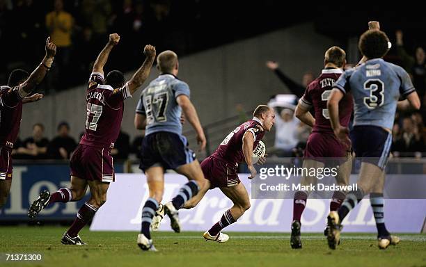 Queensland players celebrate as Darren Lockyer crosses for a try during game three of the ARL State of Origin series between the New South Wales...