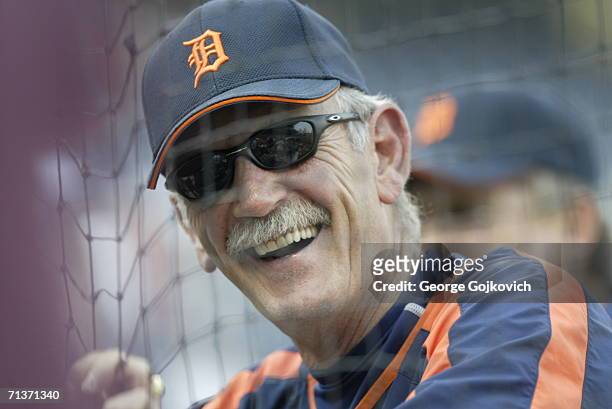 Manager Jim Leyland of the Detroit Tigers smiles while talking to fans in the stands through a fence behind home plate before the start of a game...